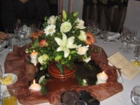 Guest table flower arrangement in pedestal pottery vase